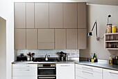 Cafetiere on hob below fitted kitchen units in contemporary London home, England, UK