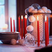 Pom-pom garland and burning red candles