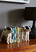 Childrens books with dog book-ends on sideboard in Rye family home, East Sussex, England, UK