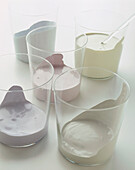 Samples of soft white emulsion paints in glass beakers