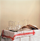 Draining board with washed dishes glasses and cutlery