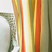Striped curtain detail with vintage chair 