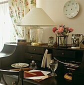 Writing desk detail with flowers and glass of water