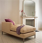 Fuscia cushion on neutral textured sofa with mirror on fire surround