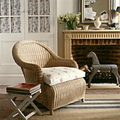 Rattan armchair with cushion co-ordinating cupboard front and rocking horse at fire surround