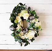Yellow roses in wreath with metal candle holders