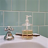 Soap dispenser and toothbrush on washbasin