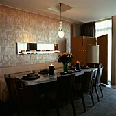 Marble dining table in room with textured wallpaper and folding screen