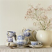 Spray of pink flowers with blue and white china