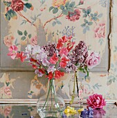 Summer flowers in vase with wallpapered picture frame