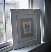 Framed picture standing near window