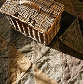 Patchwork tweed rug with rustic wicker hamper