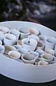 Selection of tiny porcelain Sake cups in white dish