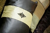 Black and white silk cushion with decorative applique