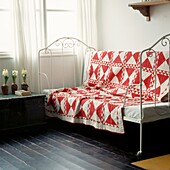 Canadian red and white quilt in 'Lady of the Lake' design from 1880's on decorative ironwork bed