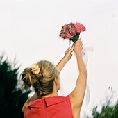 Woman catching bouquet of flowers at a wedding
