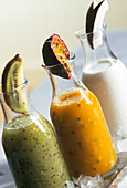 Kiwi passion fruit and coconut coolers served in glass bottles