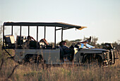 Field guides having a nap in one of the open-sided safari vehicles in the Tswalu Kalahari Game Reserve