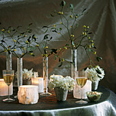 White Christmas table setting with mistletoe and silver backdrop