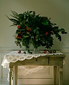 Seasonal flower arrangement on side table with lace cloth