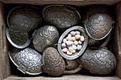 Easter eggs in metal egg-shaped caskets