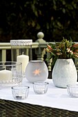 Tabletop in garden with candles and flowers