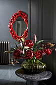 Dark grey interior with bright red ornate mirror and dramatic Peony bouquet in hall
