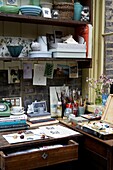 Corner of an Artists studio with painters materials and inspirational books