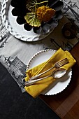 Vintage silver spoon and fork on gold napkin with plate
