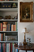 Bookshelf  table and painting on wall
