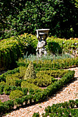 Statue of boy in ornamental garden