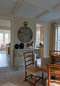 Large clock and wooden dining table in dining room of Washington DC home,  USA