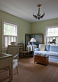 Schreibtisch und Stuhl in einem Raum mit Paravent und hellblauem Sofa in einem Haus in Washington DC, USA