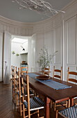 Wooden dining table with blue and white checked runner Bordeaux apartment building,  Aquitaine,  France