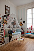 Guitars and artwork on wall of child's room in Bordeaux apartment building,  Aquitaine,  France