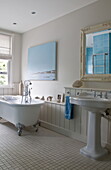 White freestanding claw-foot bath with pedestal basin in contemporary Haywards Heath home,  West Sussex,  England,  UK