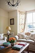 Cream sofa with wooden coffee table in bay window of Ashford home,  Kent,  England,  UK