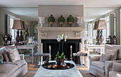 Orchid on ottoman in living room with mirrored alcoves in Battersea home,  London,  England,  UK