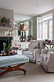 Orchid with matching armchairs in living room of Battersea home,  London,  England,  UK