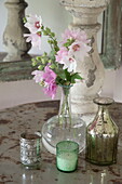Cut flowers and vintage vases on side table in Kingston home,  East Sussex,  England,  UK