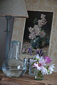 Schnittblumen und Kunstwerk mit Lampe im Haus in Kingston, East Sussex, England, UK