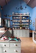 Chinaware on kitchen dresser in blue double height kitchen of Tiverton farmhouse  Devon  UK