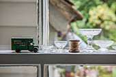 Matchbox removal van with glassware  needle and thread on sash window in Kent home  England  UK