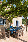 Blue cloth on table below pergola at stone barn conversion in Lotte et Garonne  France