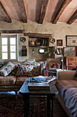 Embroidered cushions on sofa with niche shelving in Lotte et Garonne barn conversion  France