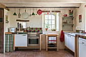 Kitchenware on rail with uncurtained window in Lotte et Garonne farmhouse  France