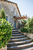 Stone steps with awning above terrace outside Lotte et Garonne farmhouse  France