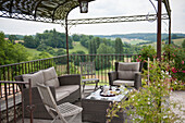 Wicker furniture on terrace with view of Dordogne countryside  Perigueux  France