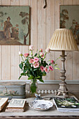 Cream lampshade and cut roses with artwork in Dordogne cottage  Perigueux  France