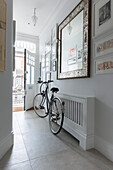 Italian mirror and bicycle in hallway of South London Victorian terrace  UK